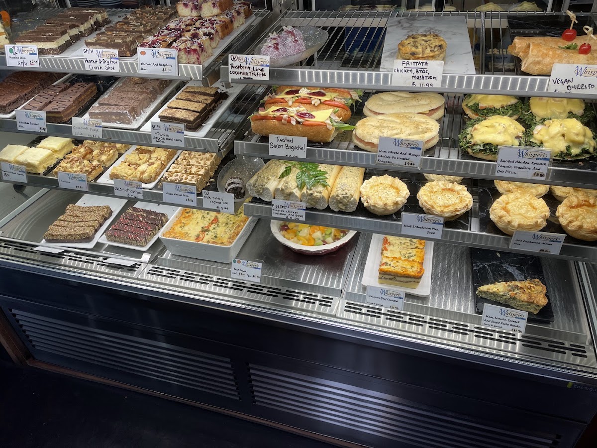 The Whispers food cabinet, full of slices and quiches