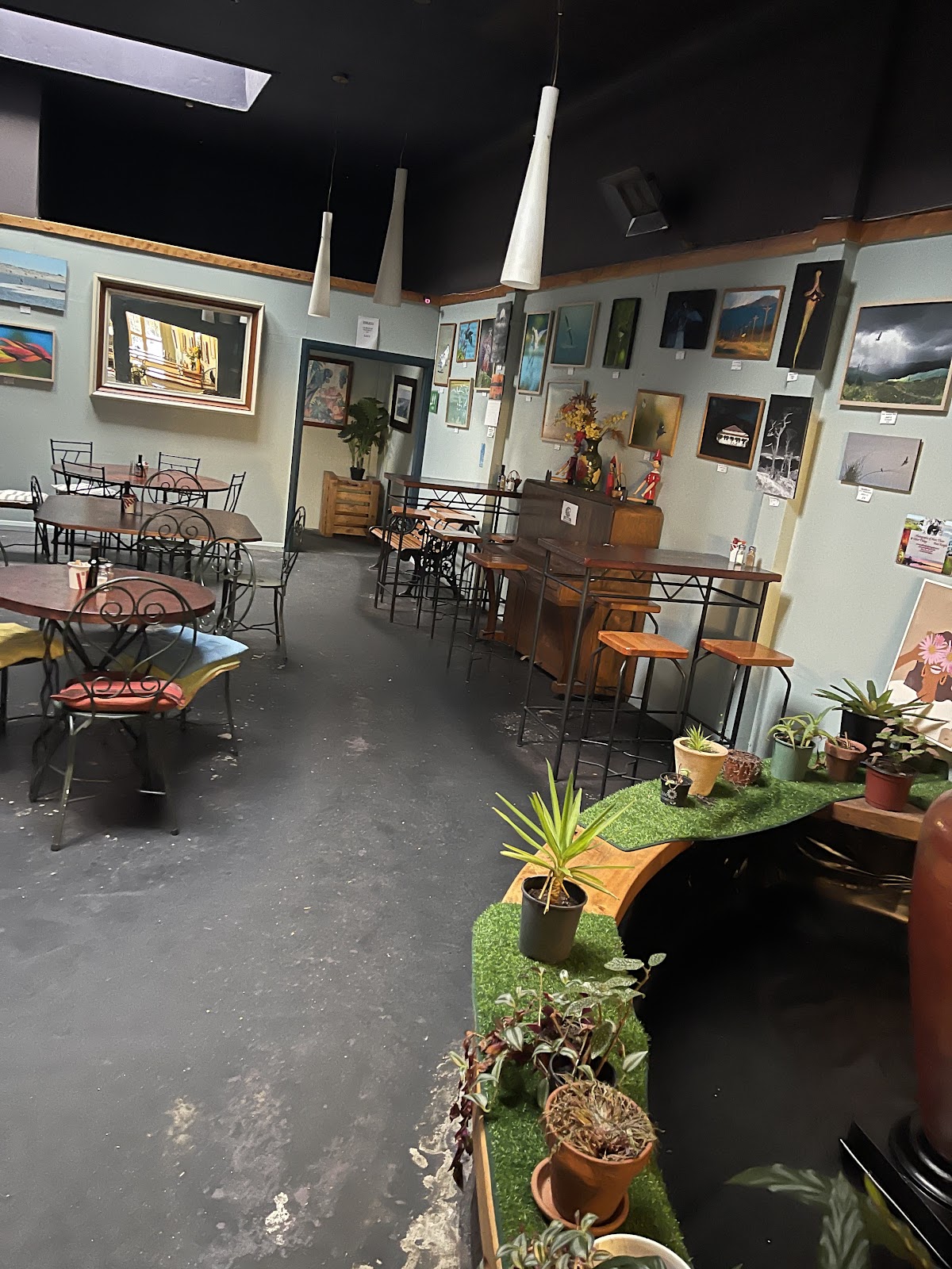 The Whispers dining room, local artists' work hung across the walls