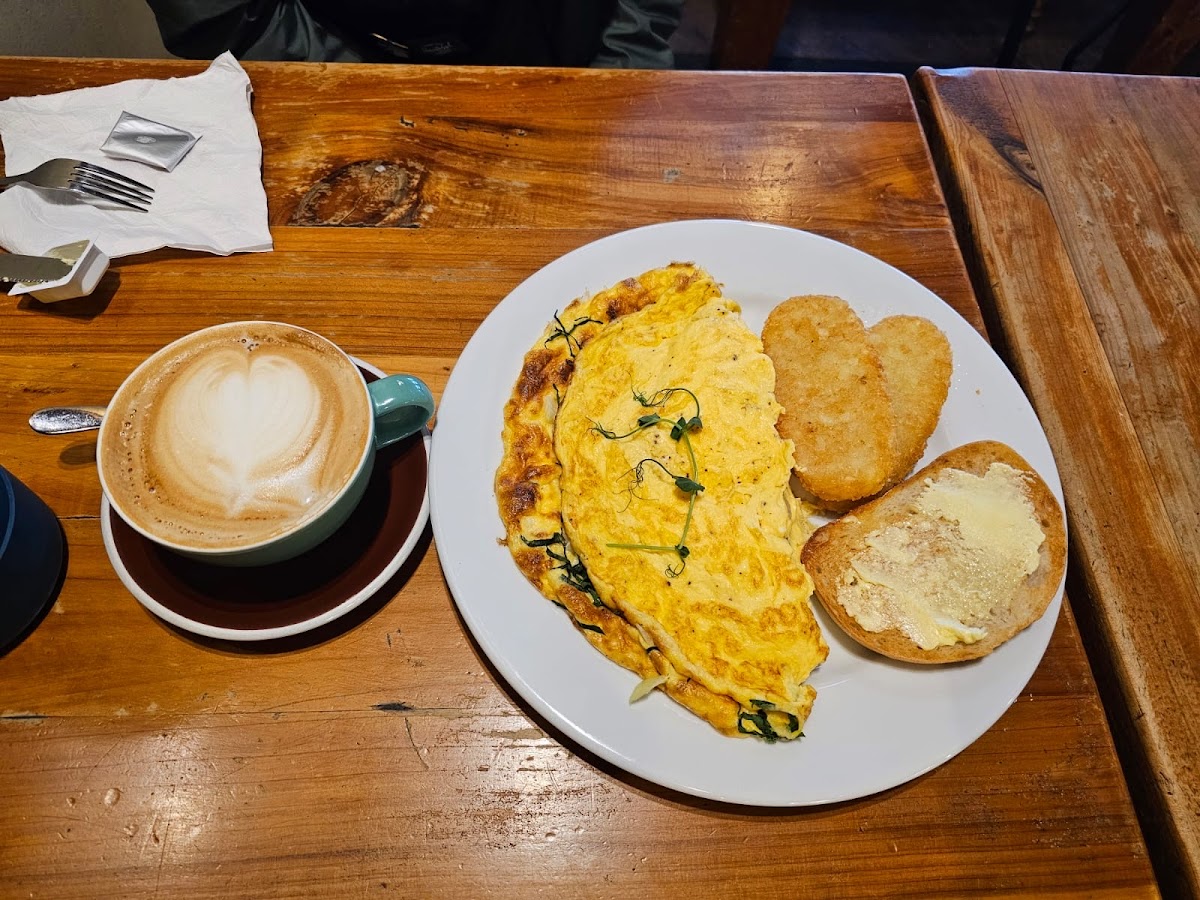 Cheese omelette with hash browns and a heart latte